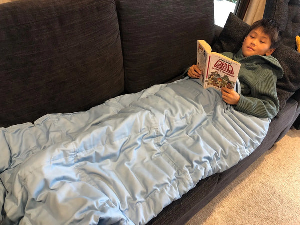 Person relaxing with a weighted blanket